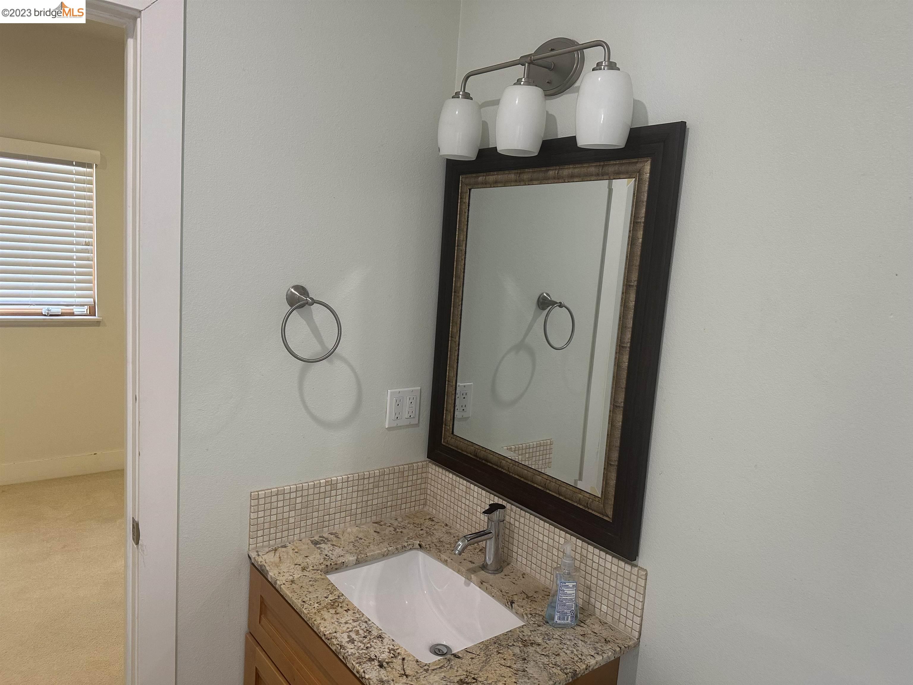 2191 Pleasant Hill Road Pleasant Hill, CA 94523 - Photo 7 of 35 a bathroom with a granite countertop sink a mirror and vanity