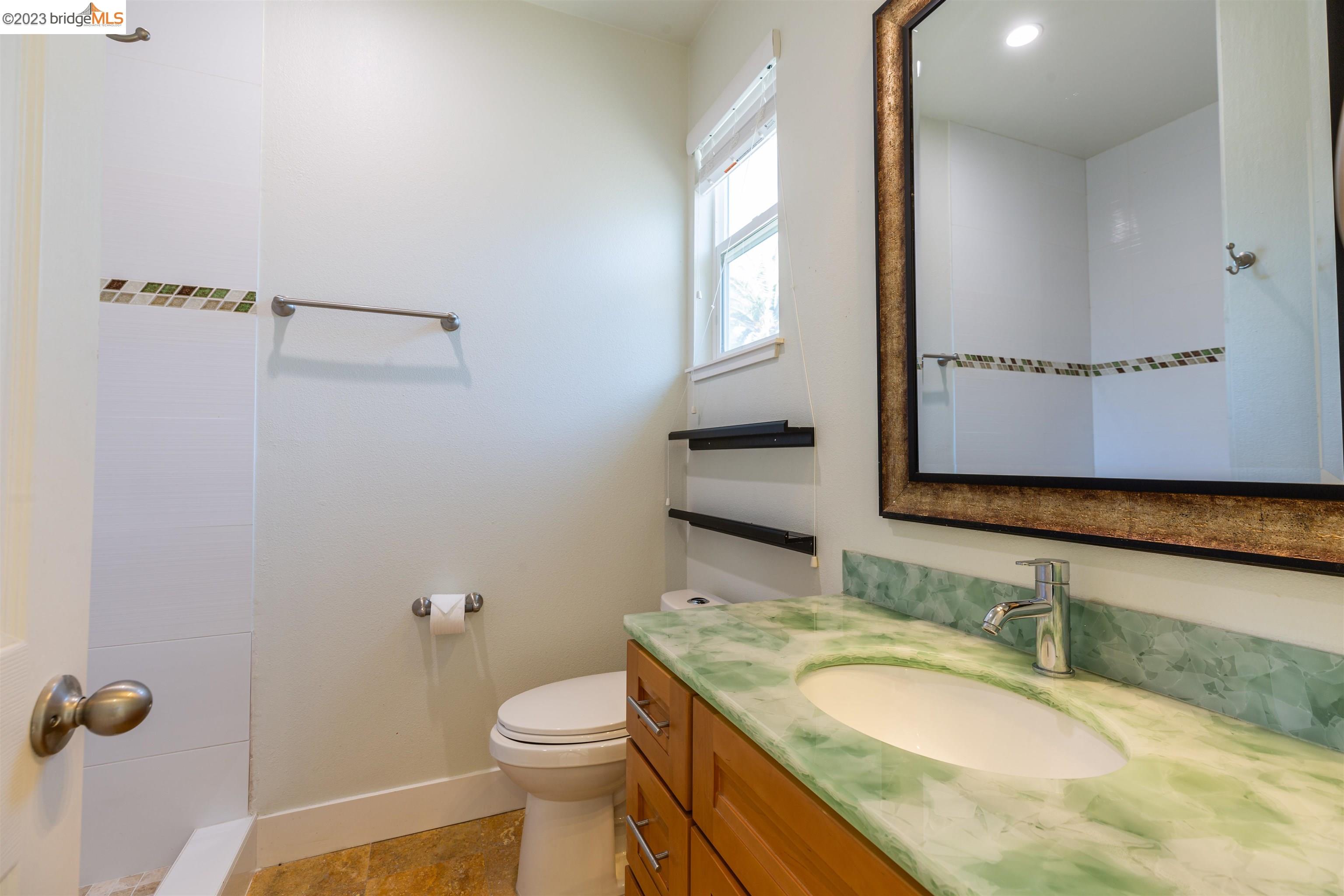 2191 Pleasant Hill Road Pleasant Hill, CA 94523 - Photo 10 of 35 a bathroom with a granite countertop sink and a mirror