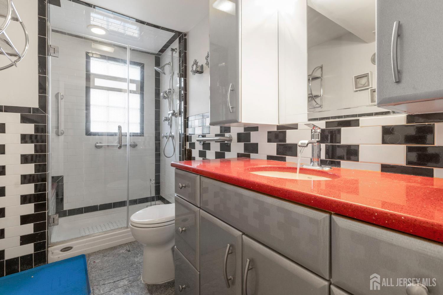 55 Sullivan Way East Brunswick, NJ 08816 - Photo 11 of 38 a bathroom with a sink a toilet and shower