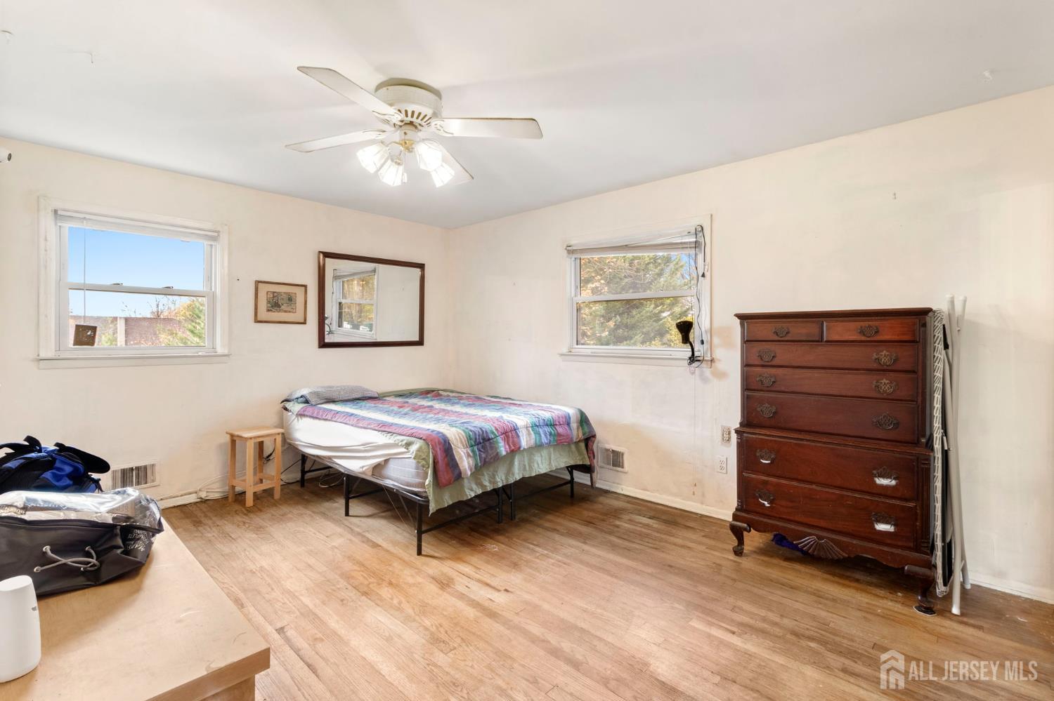 55 Sullivan Way East Brunswick, NJ 08816 - Photo 17 of 38 a bedroom with a bed and a chandelier