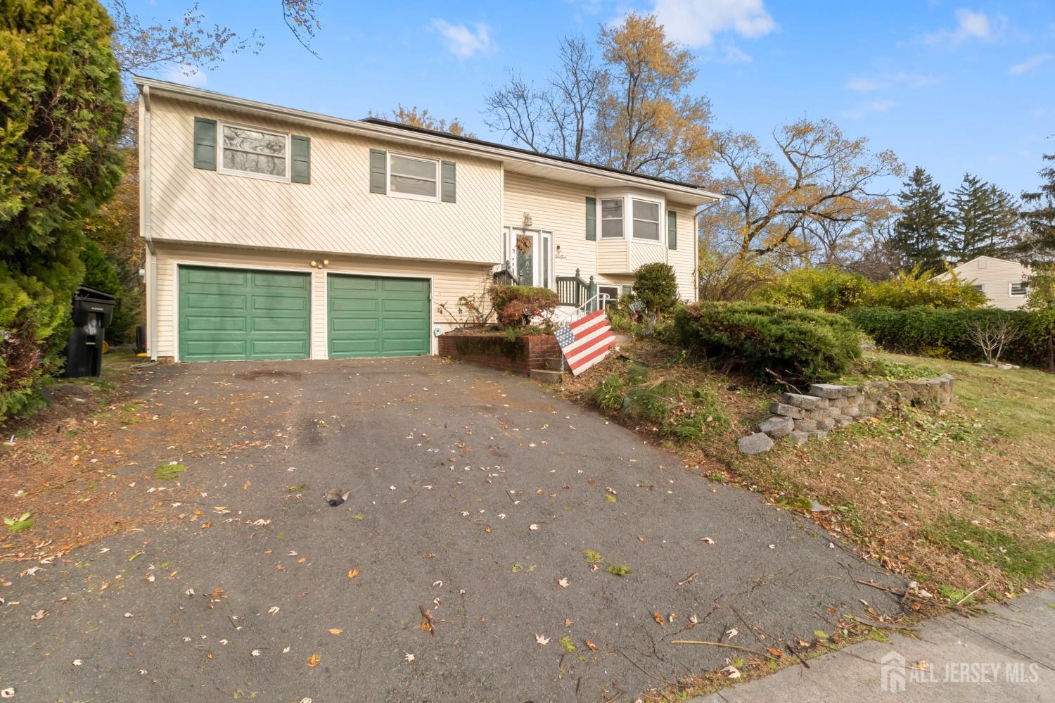 55 Sullivan Way East Brunswick, NJ 08816 - Photo 2 of 38 a view of a house with a yard and garage