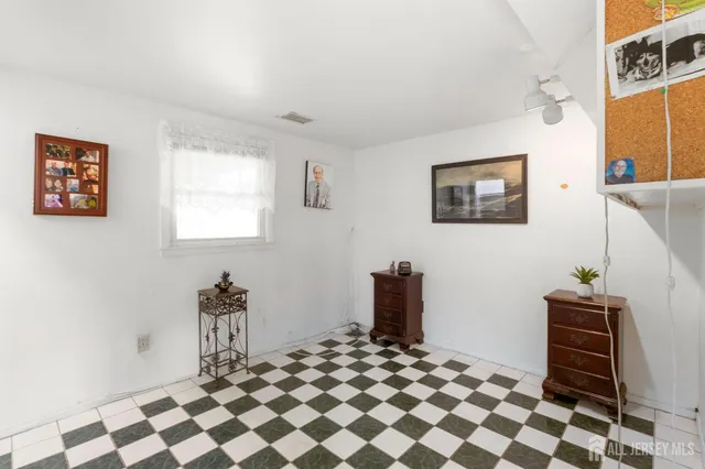 a room with a black white checkered floor with a white walls and a black white checkered floor