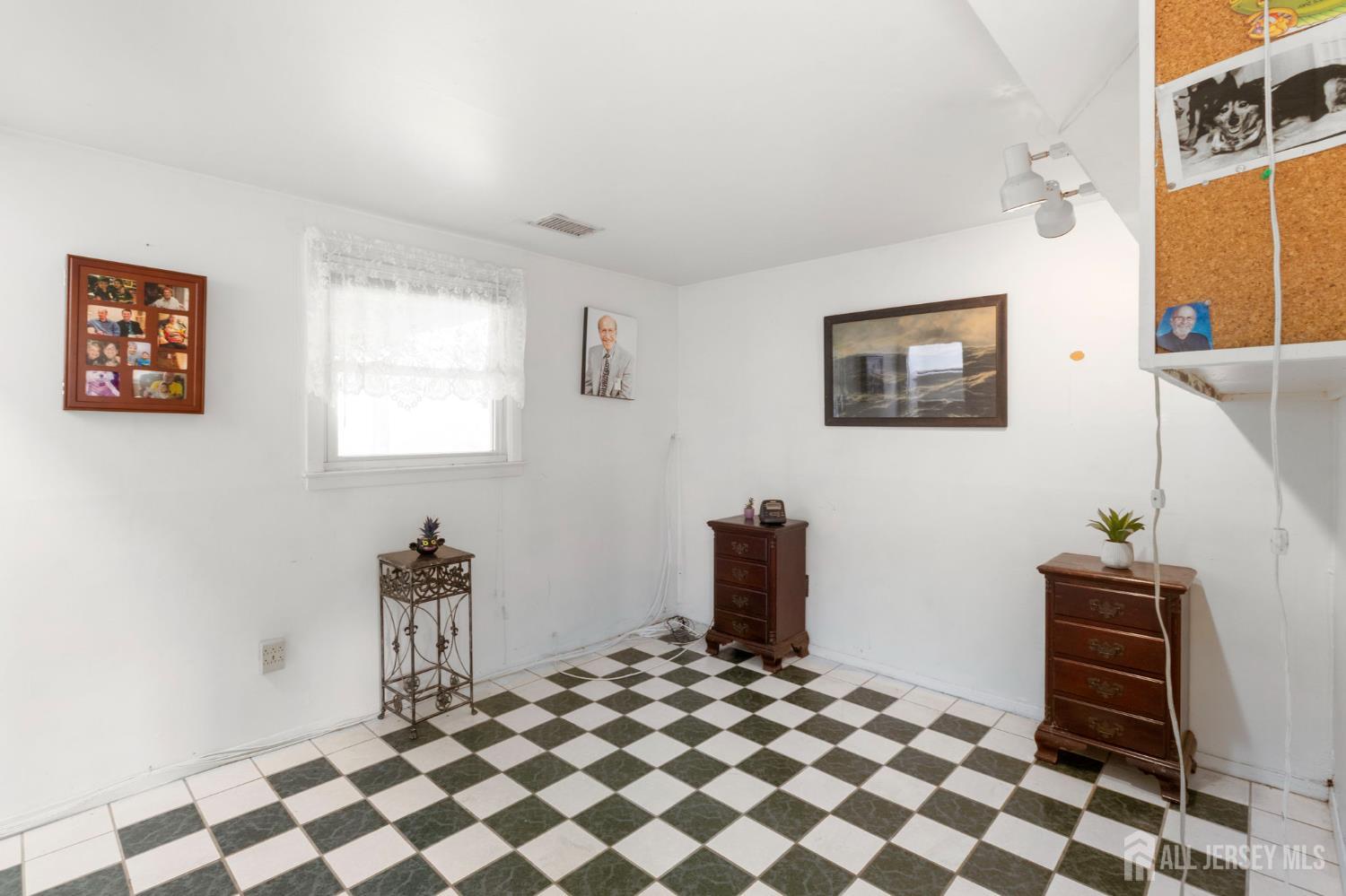 55 Sullivan Way East Brunswick, NJ 08816 - Photo 6 of 38 a room with a black white checkered floor with a white walls and a black white checkered floor