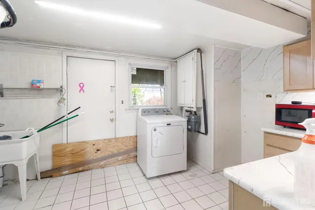 a kitchen with a sink cabinets and appliances
