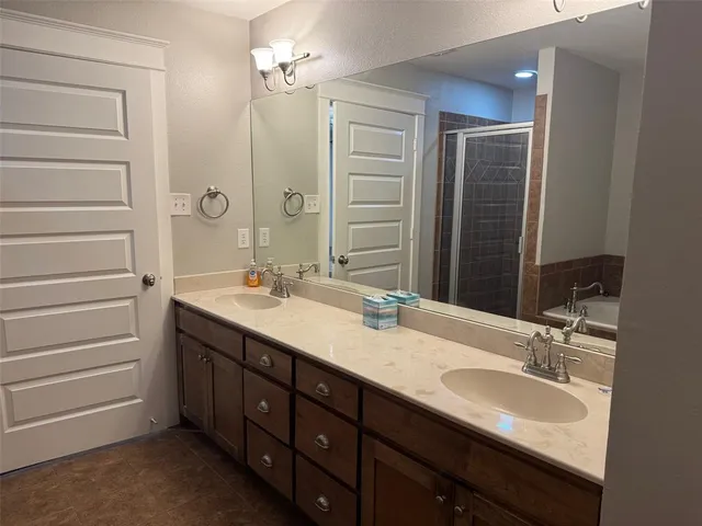 a bathroom with a double vanity sink a and a mirror