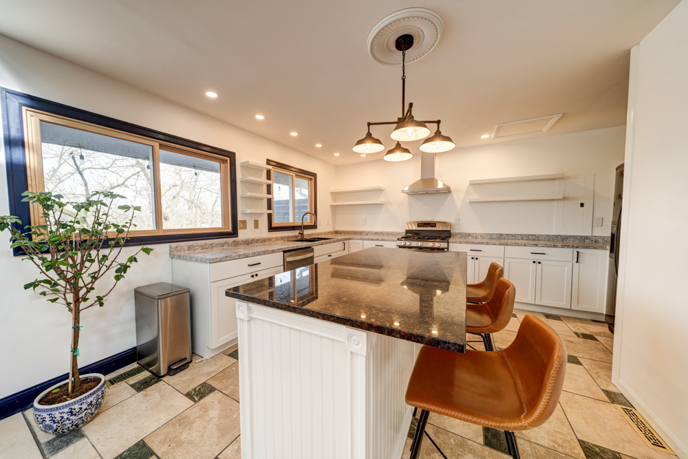 422 Castle Road McHenry, IL 60050 - Photo 12 of 24 a kitchen with stainless steel appliances granite countertop a sink a stove and a refrigerator
