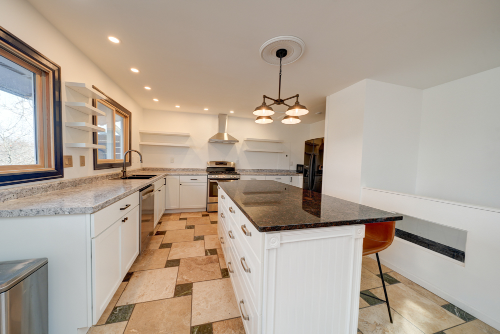 422 Castle Road McHenry, IL 60050 - Photo 13 of 24 a kitchen with stainless steel appliances granite countertop a sink and a refrigerator