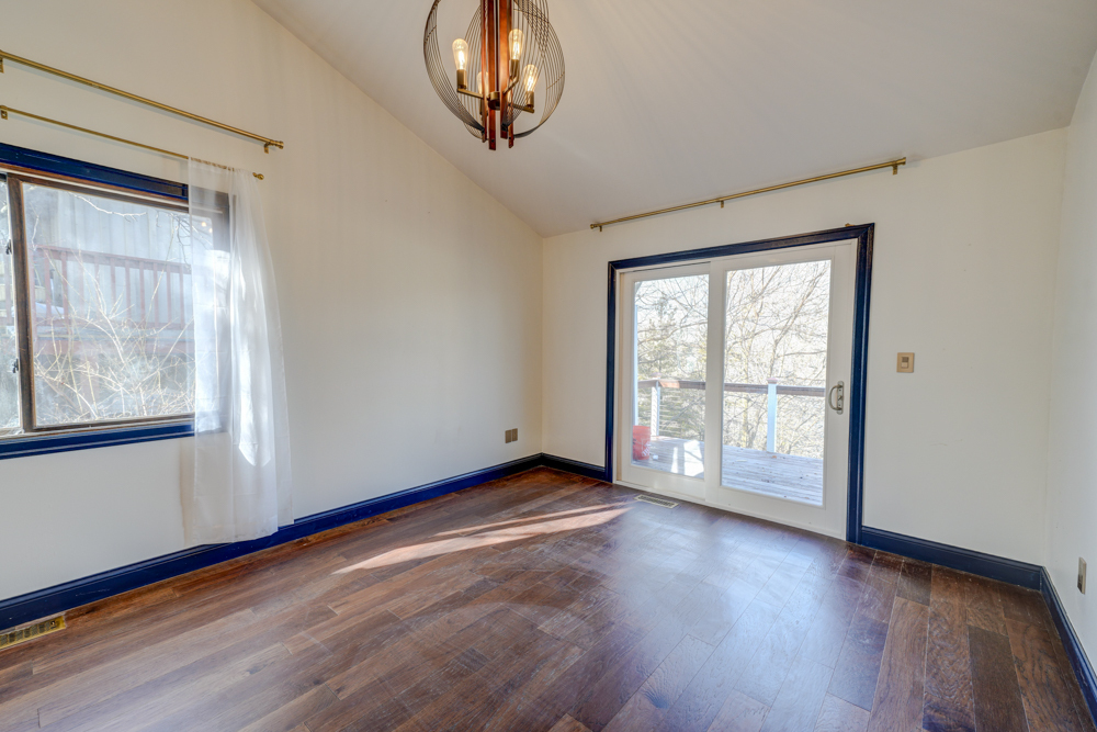 422 Castle Road McHenry, IL 60050 - Photo 14 of 24 a view of an empty room with wooden floor and a window