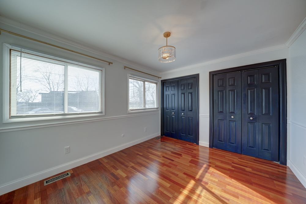 422 Castle Road McHenry, IL 60050 - Photo 16 of 24 a view of empty room with wooden floor and fan