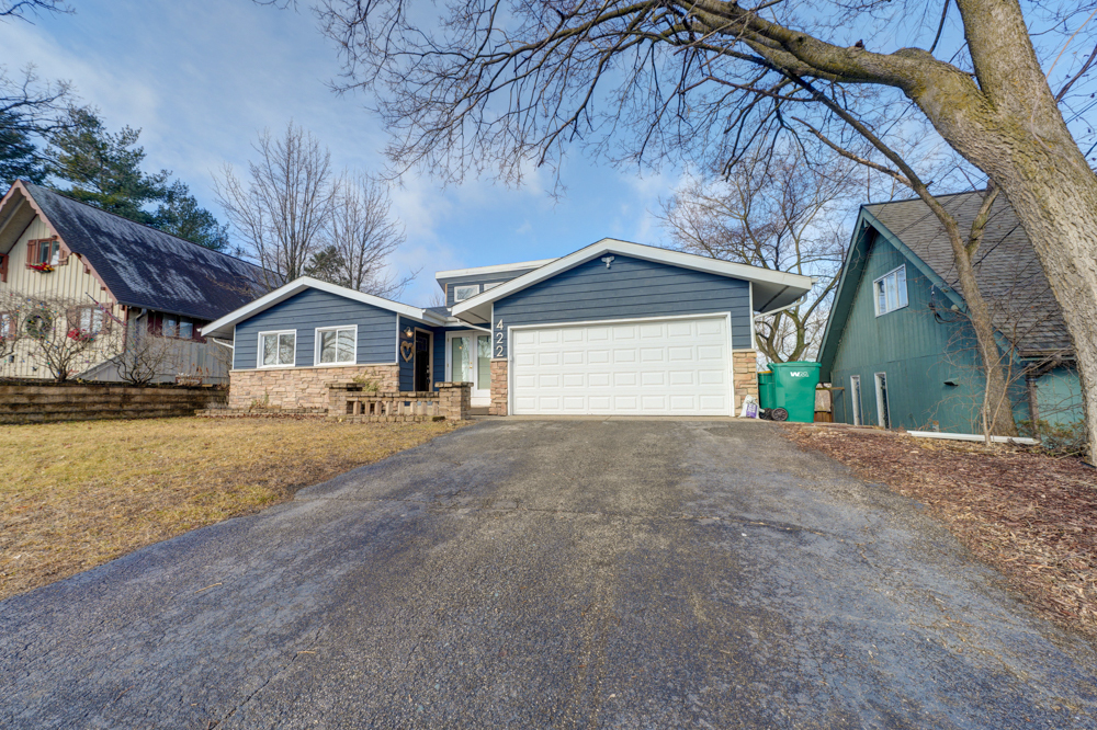 422 Castle Road McHenry, IL 60050 - Photo 2 of 24 a front view of a house with a yard and garage