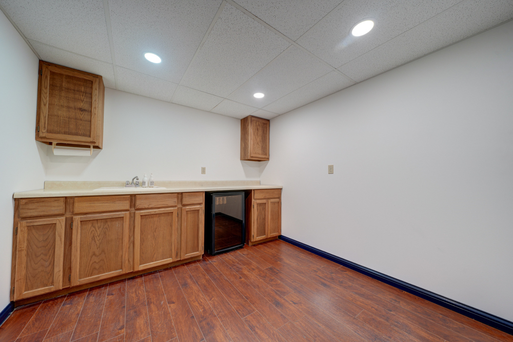 422 Castle Road McHenry, IL 60050 - Photo 21 of 24 a room with granite countertop white cabinets and wooden floor