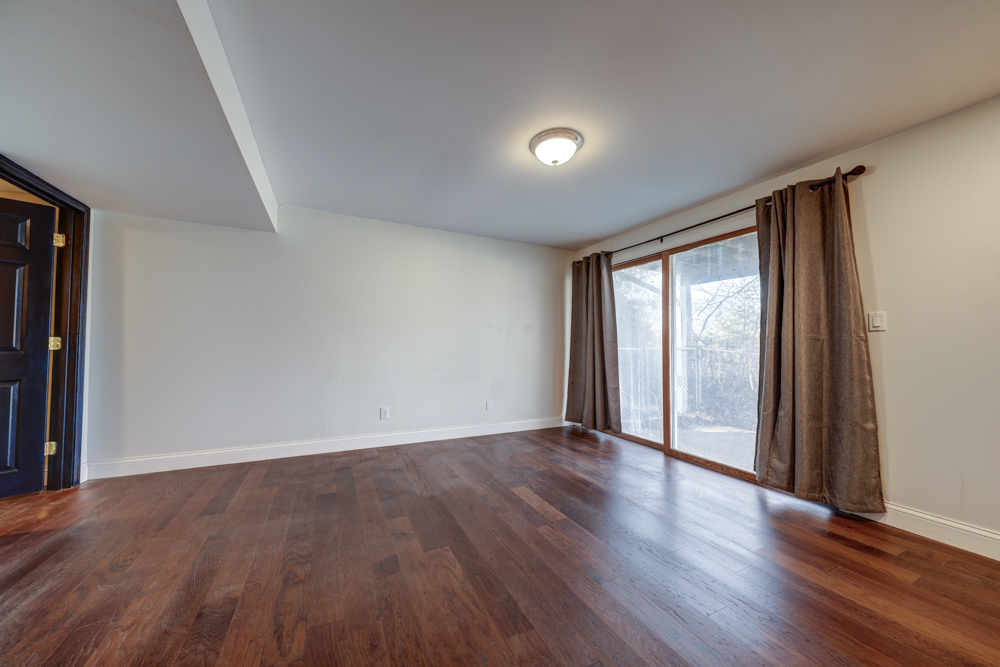 422 Castle Road McHenry, IL 60050 - Photo 23 of 24 a view of an empty room with wooden floor and a window