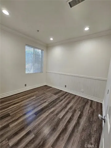 a view of a room with wooden floor and window
