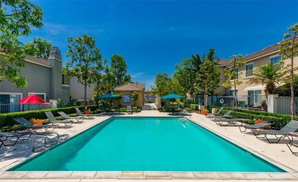 a view of a swimming pool with a patio and a garden