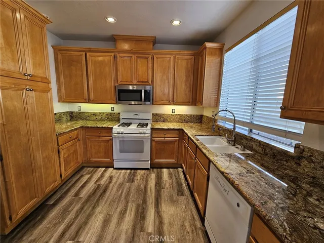 a kitchen with a sink stove top oven and cabinets