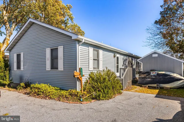 a view of a backyard with plants and a patio