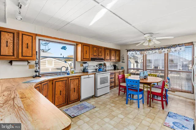 a kitchen with granite countertop lots of counter top space dining table and stainless steel appliances