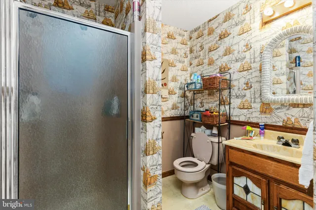 a view of bathroom with a toilet and a shower curtain