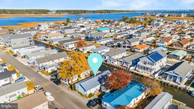 an aerial view of residential building with outdoor space and ocean view