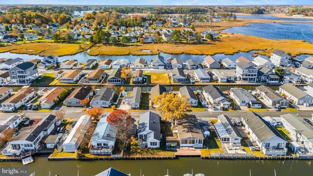an aerial view of residential building with outdoor space and ocean view