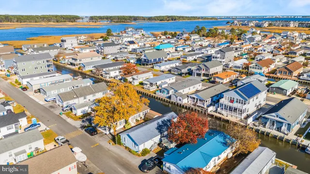 an aerial view of multiple houses with a street