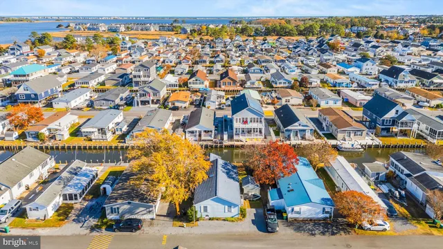 a view of a house next to a lake with houses