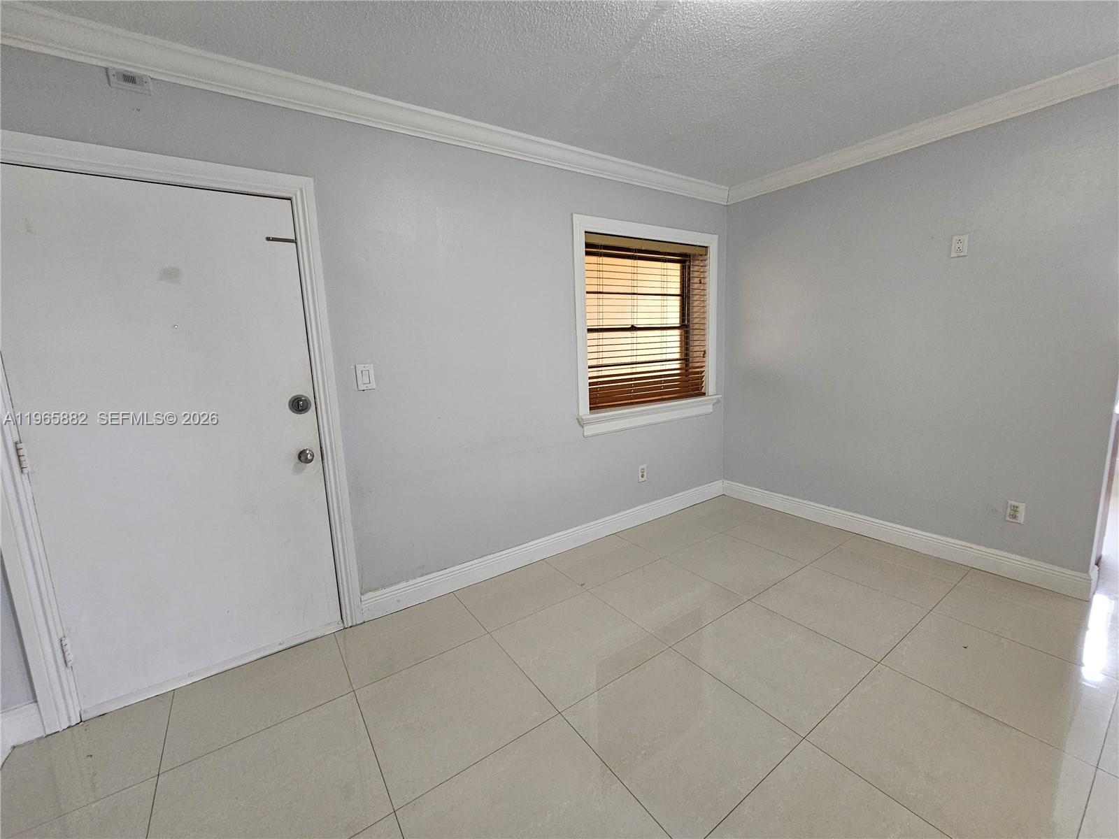 47 Northwest 47th Avenue, Unit 16 Miami, FL 33126 - Photo 3 of 10 a view of an empty room with a window