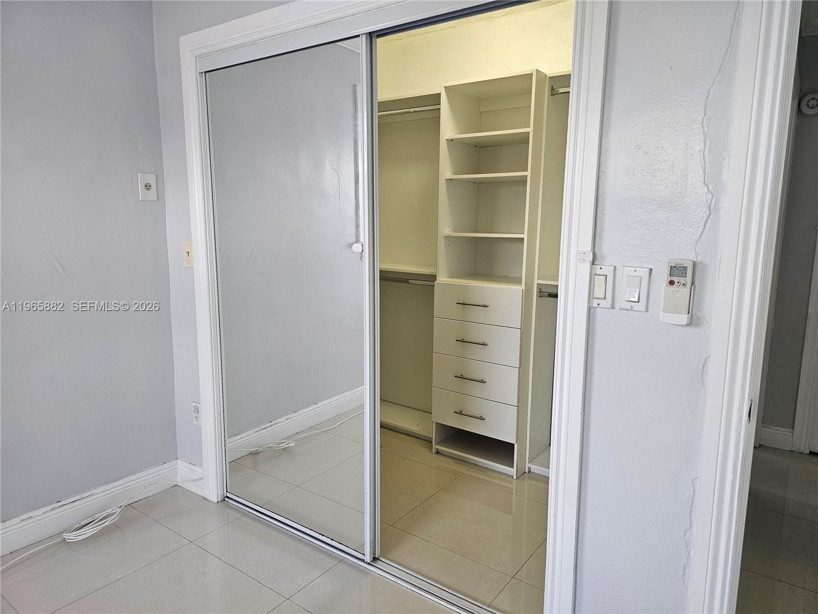 47 Northwest 47th Avenue, Unit 16 Miami, FL 33126 - Photo 6 of 10 a view of walk in closet with empty racks