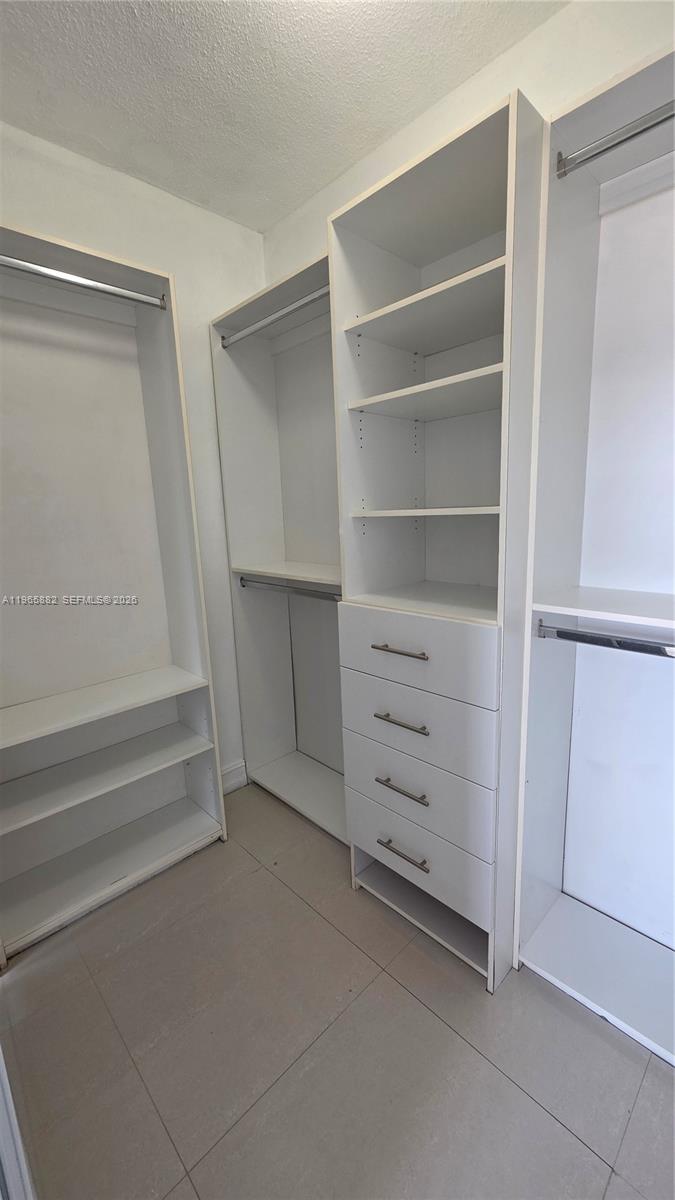 47 Northwest 47th Avenue, Unit 16 Miami, FL 33126 - Photo 7 of 10 a view of walk in closet with empty racks