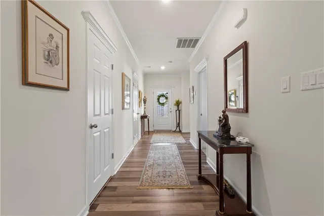 a view of a hallway with wooden floor and entryway