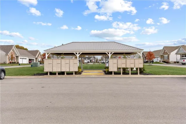 a front view of a house with a garden and plants