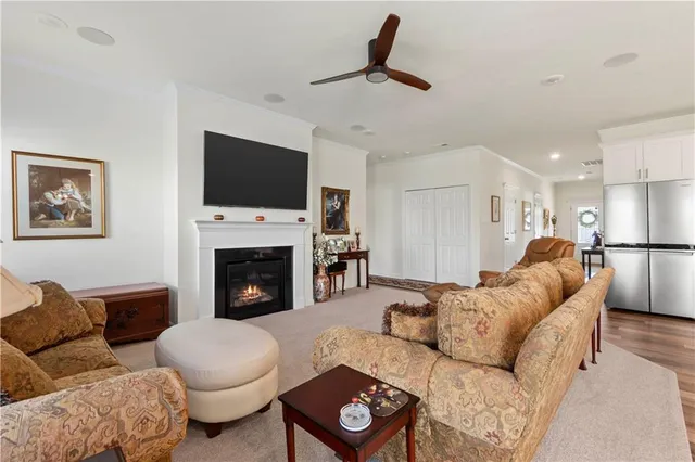 a living room with furniture a flat screen tv and a fireplace