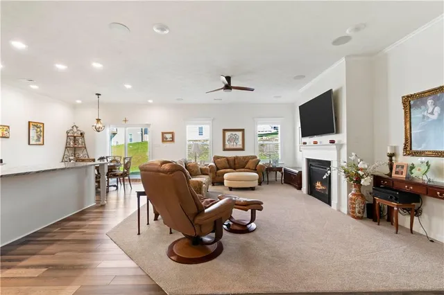 a living room with furniture a fireplace and a flat screen tv