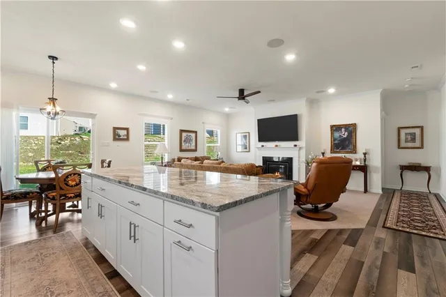 a kitchen with sink refrigerator and dining table chair