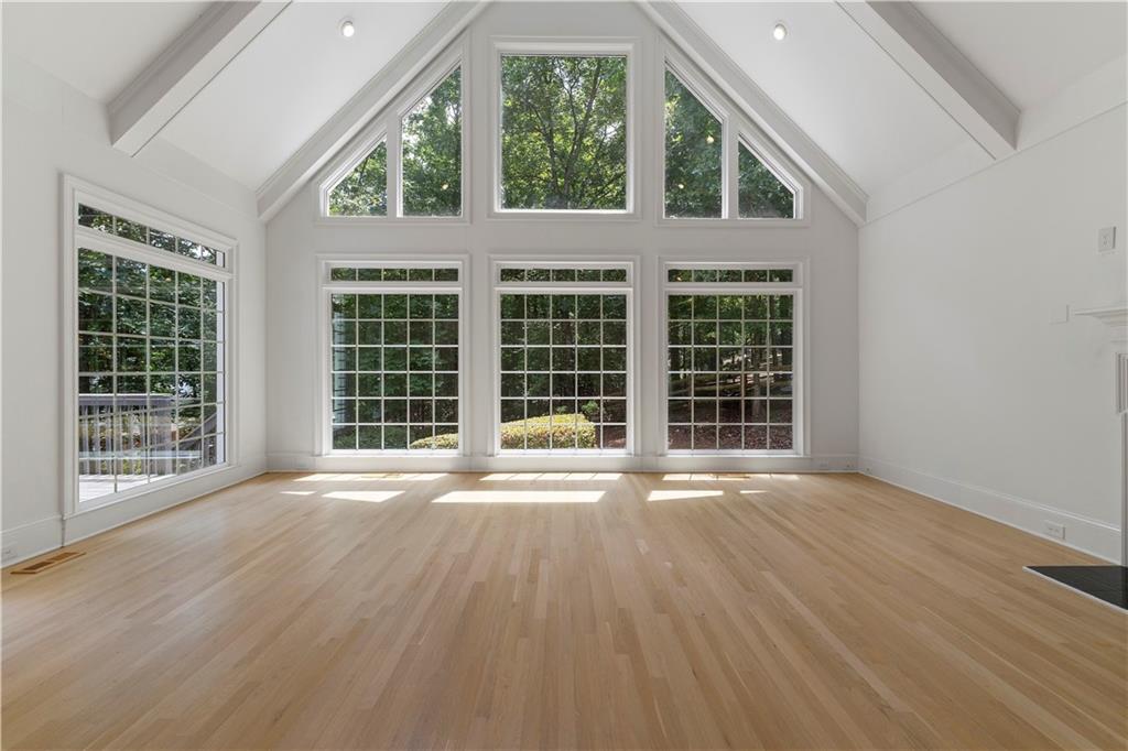 8965 Laurel Way Alpharetta, GA 30022 - Photo 7 of 79 an empty room with wooden floor and windows