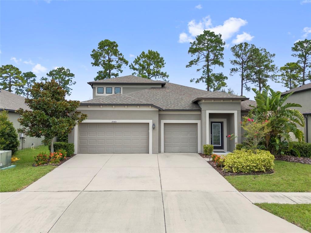 18565 Obregan Drive Spring Hill, FL 34610 - Photo 1 of 70 a house view with a garden space