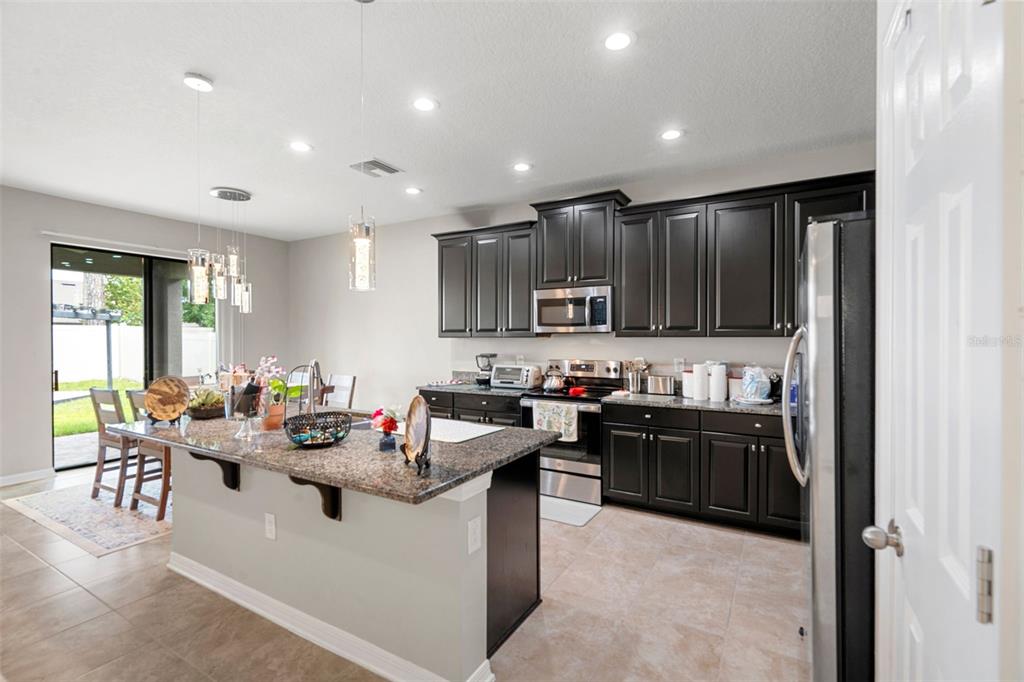 18565 Obregan Drive Spring Hill, FL 34610 - Photo 17 of 70 a kitchen with sink refrigerator and cabinets