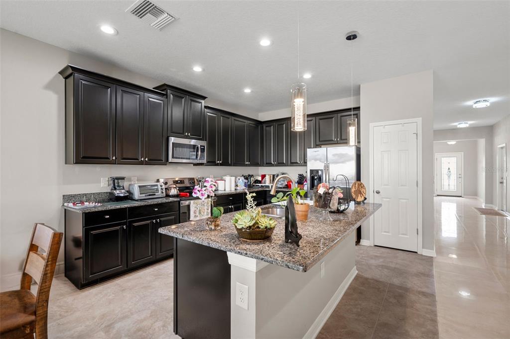 18565 Obregan Drive Spring Hill, FL 34610 - Photo 18 of 70 a kitchen with sink cabinets and stove top oven