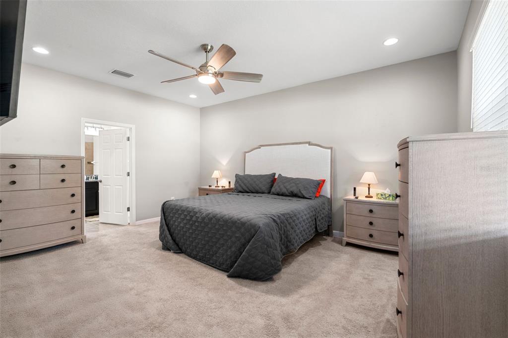 18565 Obregan Drive Spring Hill, FL 34610 - Photo 23 of 70 a bedroom with a bed and ceiling fan