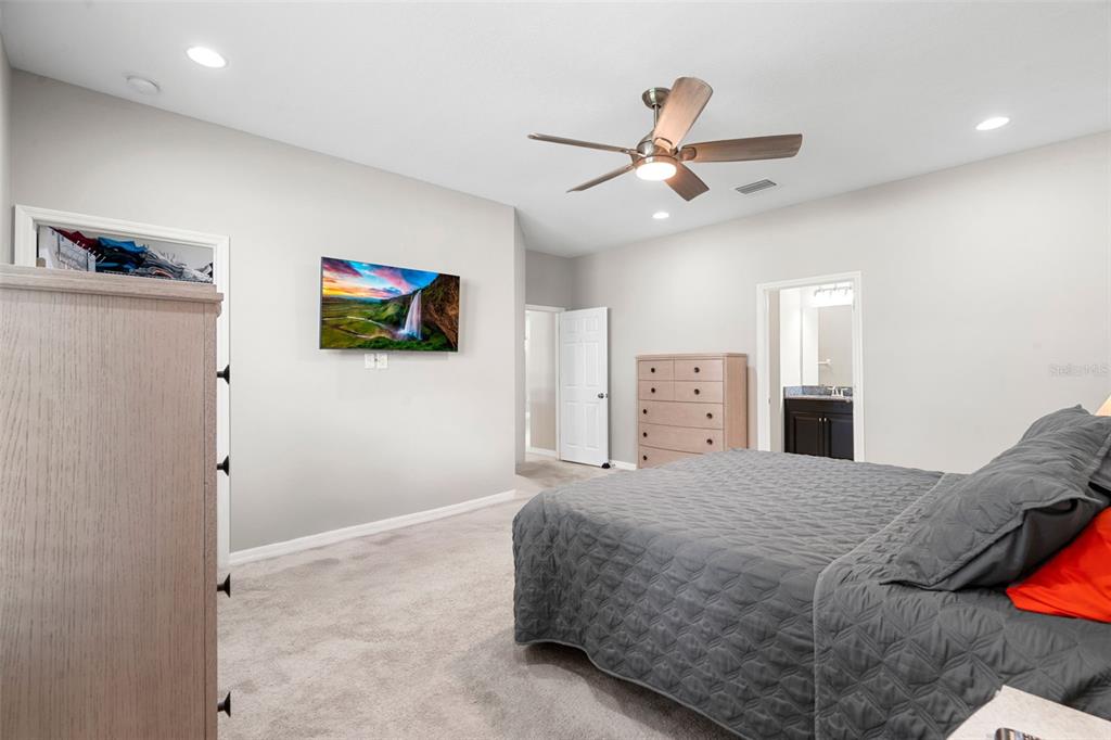 18565 Obregan Drive Spring Hill, FL 34610 - Photo 24 of 70 a bedroom with a bed and a ceiling fan
