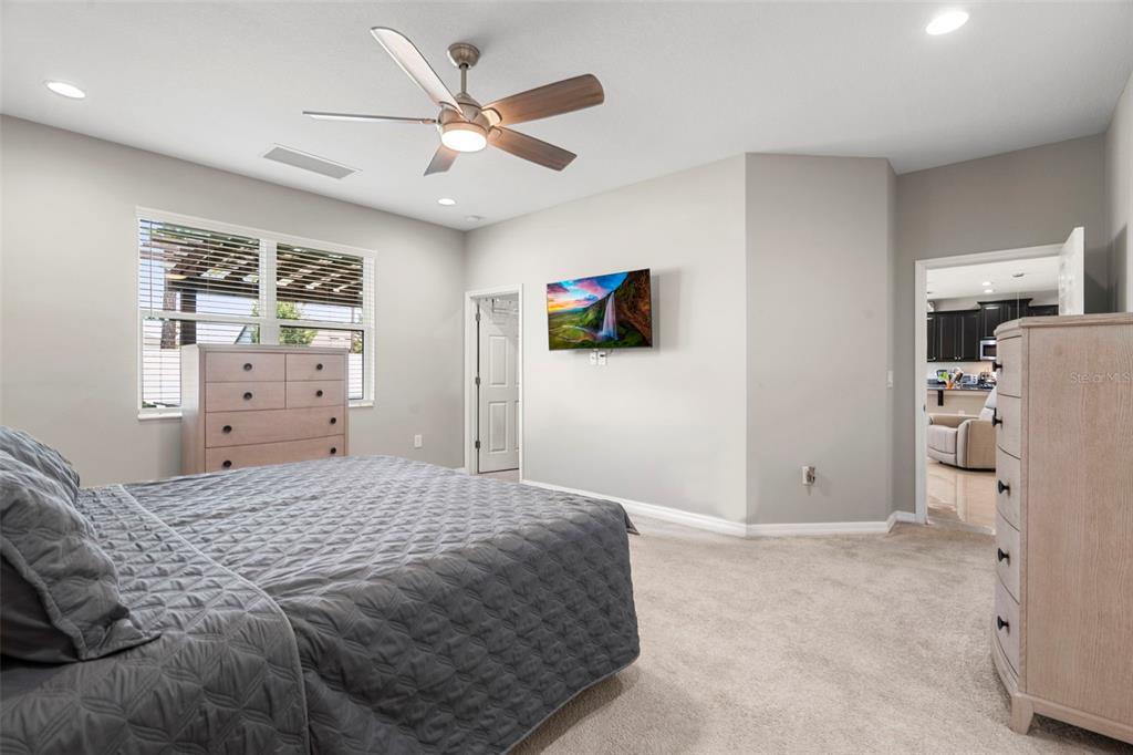 18565 Obregan Drive Spring Hill, FL 34610 - Photo 25 of 70 a bedroom with a bed and a flat screen tv