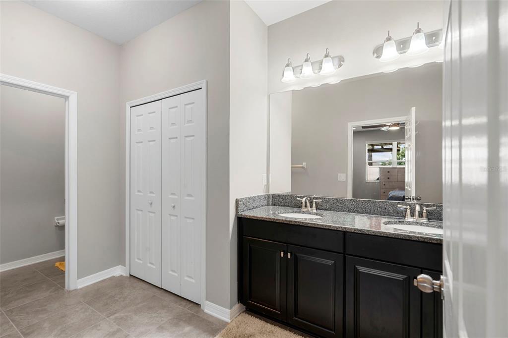 18565 Obregan Drive Spring Hill, FL 34610 - Photo 28 of 70 a bathroom with a double vanity sink and a mirror