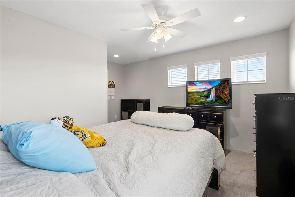 18565 Obregan Drive Spring Hill, FL 34610 - Photo 41 of 70 a bedroom with a bed and ceiling fan