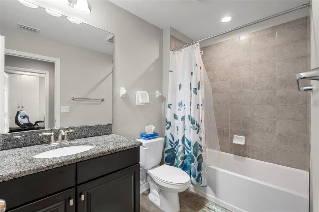 18565 Obregan Drive Spring Hill, FL 34610 - Photo 42 of 70 a bathroom with a granite countertop sink toilet and shower