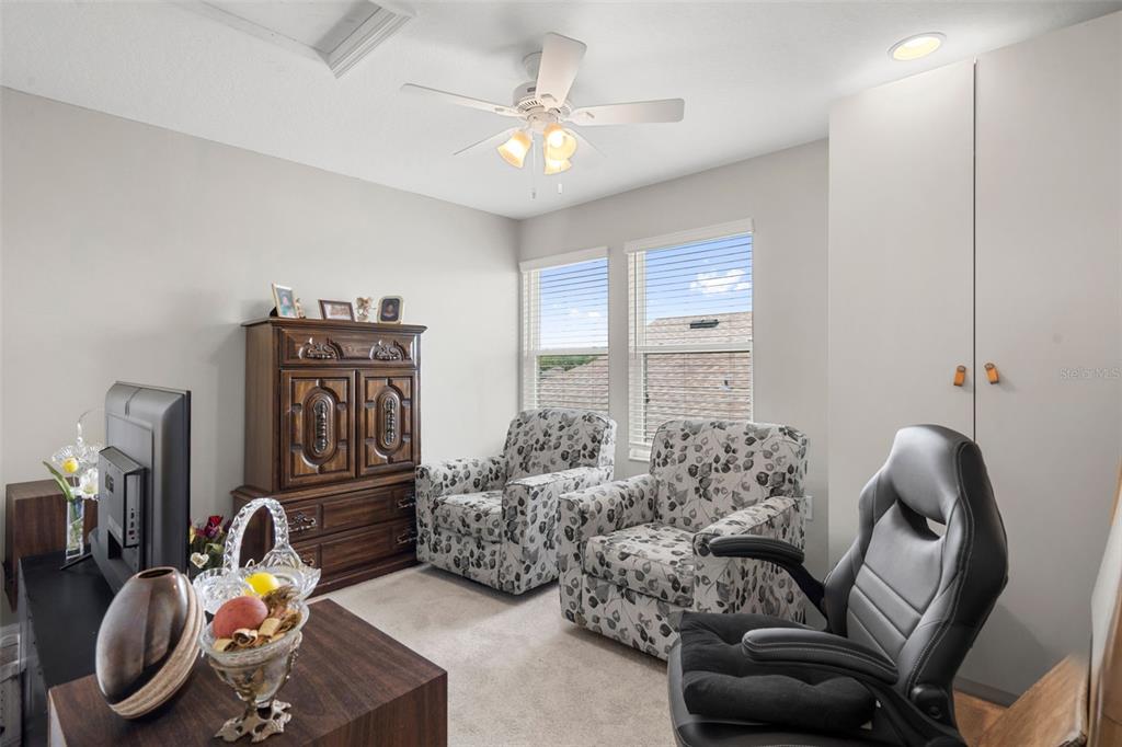 18565 Obregan Drive Spring Hill, FL 34610 - Photo 46 of 70 a bedroom with furniture and a chandelier