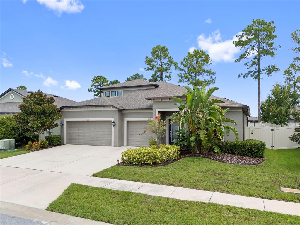 18565 Obregan Drive Spring Hill, FL 34610 - Photo 5 of 70 a front view of a house with a garden