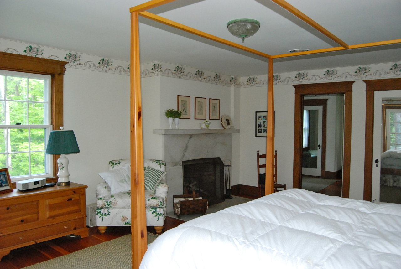 55 Eaton Road Monterey, MA 01245 - Photo 19 of 48 a bedroom with a bed and a flat tv screen