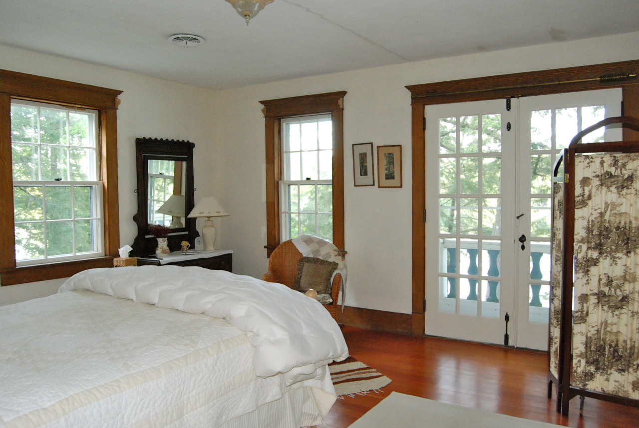 55 Eaton Road Monterey, MA 01245 - Photo 24 of 48 a bedroom with a bed and wooden floor