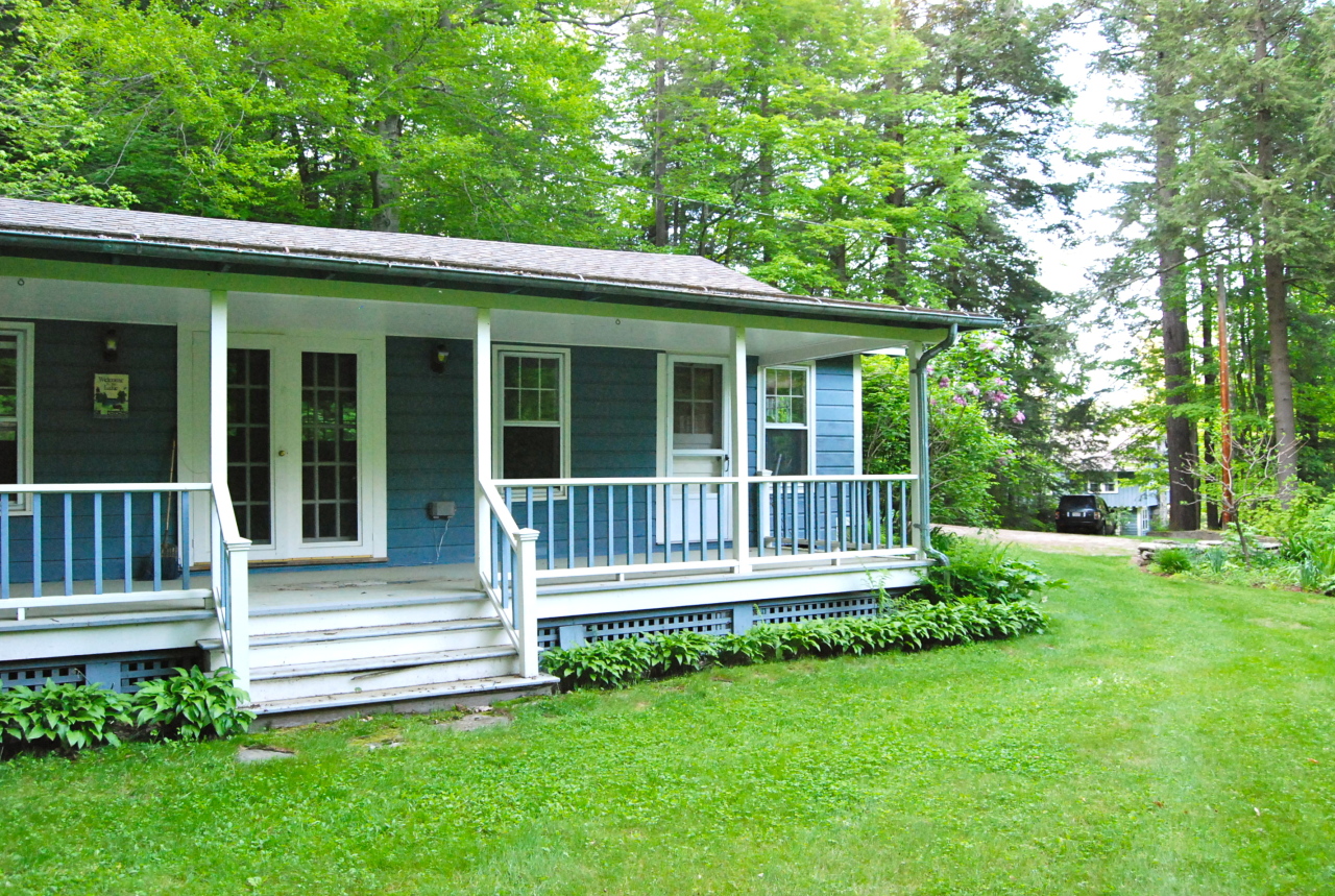 55 Eaton Road Monterey, MA 01245 - Photo 33 of 48 a view of a house with a backyard and a large tree