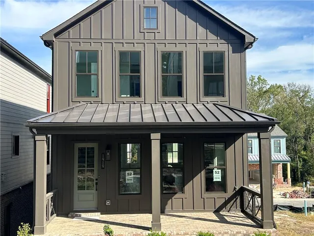 a front view of a house with a yard patio and furniture